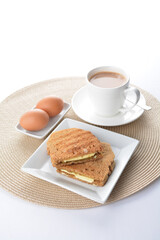 Fototapeta na wymiar butter toast bread set with half boiled egg and coffee or tea in white background asian halal menu