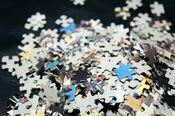 jigsaw puzzle on wooden background. to represent how complexity in game and challenge. plan and goal as concept.	
