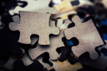 jigsaw puzzle on wooden background. to represent how complexity in game and challenge. plan and goal as concept.	
