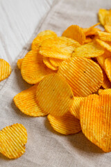 Ruffled Cheese Potato Chips, side view. Close-up.