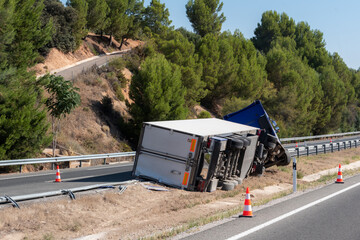 Truck with an accident refrigerated semi-trailer, overturned by the exit of the highway in the...