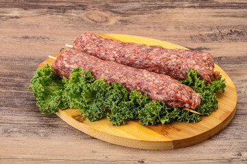Raw minced beef kebab skewer
