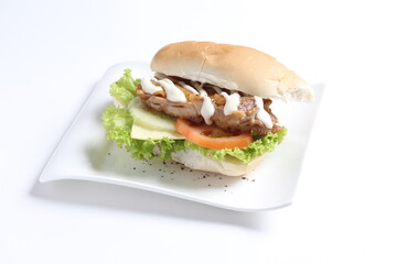 speciality grill bbq chicken burger with sliced cheese and vegetables in white background western fast food halal menu