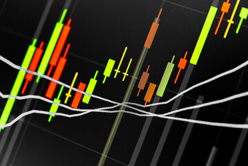 Abstract financial trading graphs and digital number of foreign exchange market trading on monitor. Background of gold and blue digital chart to represent stock market trend.