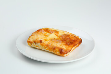 cottage cheese casserole in white plate closeup with copy space. cottage cheese casserole isolated om white