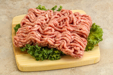 Raw pork minced meat over board