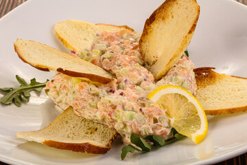 Tartar with salmon fish served lemon