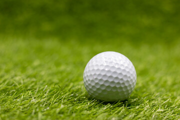 Golf ball is on green grass