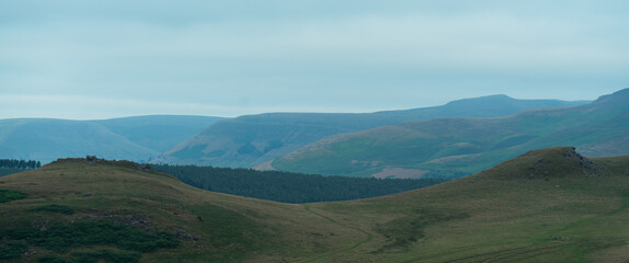 a large green field with a mountain in the background