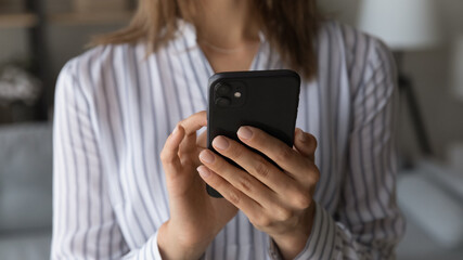 Woman texting message on cellphone, dialling number make call, close up view female hands and modern gadget. Blogging, online chat, social media, generation addict to wireless device, internet concept