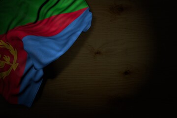 pretty dark illustration of Eritrea flag with large folds on dark wood with empty place for text - any celebration flag 3d illustration..