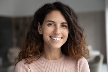 Headshot portrait of smiling millennial Latino woman look at camera pose in home feel optimistic. Profile picture of happy young Hispanic female show white healthy teeth. Diversity concept. - obrazy, fototapety, plakaty
