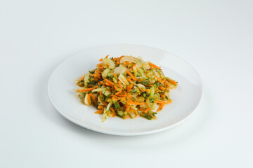 celery salad with carrot closeup on white plate. salad isolated on white