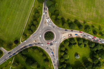 Aerial view of busy road roundabout at peak time rush hour