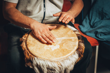 The drummer plays the ethnic percussion musical instrument djembe