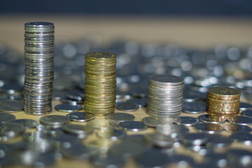 Closeup coins stack building. Many coins on foreground and background of the stack. Bokeh effect on background. Malaysia ringgit currency. 