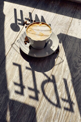 a cup of coffee on the table and coffee beans wi-fi free