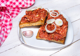 Detail of Czech toasted breads with raw beef steak tartare, garlic and onions.