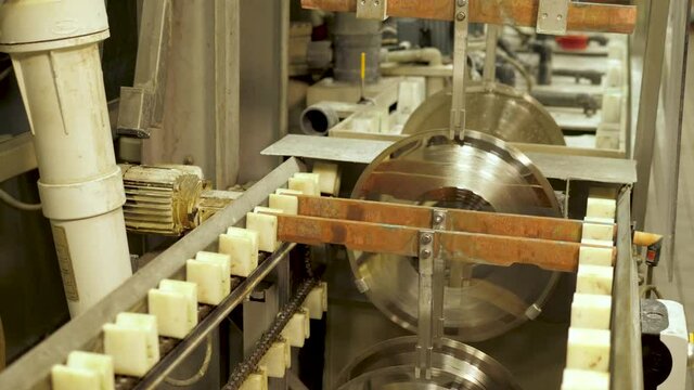Vinyl record factory: Lacquers picked up by machine before dipping into a nickle bath