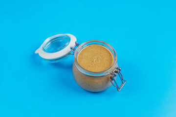 Homemade peanut butter in a jar and bowl.