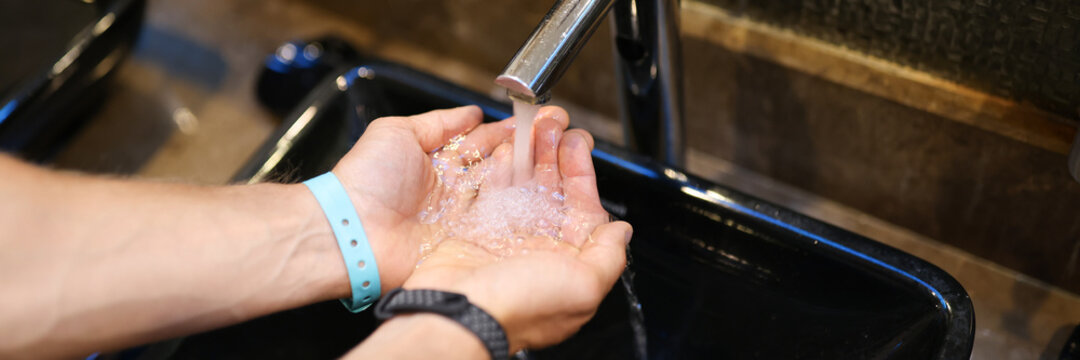 Washing hands in sink. Clean hands guarantee health