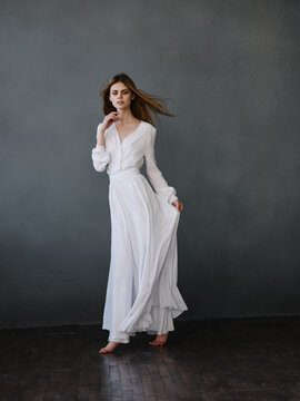 Woman in white luxury dress posing fashion