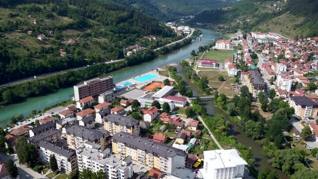 Aerial drone view of Foca, Bosnia and Herzegovina. Drina river and city of Foca in summer, view from above. Buildings, streets and residential houses.