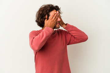 Young caucasian man isolated on white background afraid covering eyes with hands.