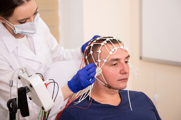 Patient brain testing using encephalography at medical center