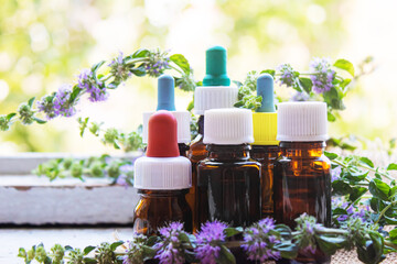 Thyme essential oil in a small bottle. selective focus .