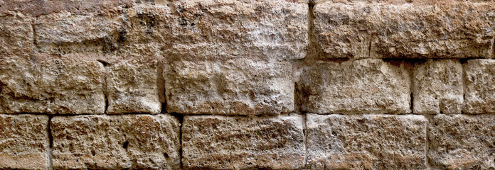 ancient stonewall fort or stronghold - surface of brown rock bricks texture in an horizontal format