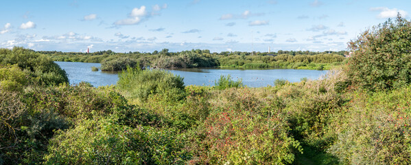 Panorama of Westerplas lake with lighthouse and water tower on Schiermonnikoog, Netherlands