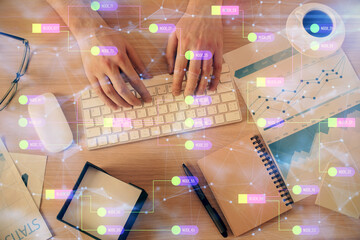 Double exposure of man's hands typing over computer keyboard and data theme hologram drawing. Top view. Technology concept.