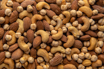 A mixture of cashews, almonds and chickpeas. Roasted nuts with salt. High protein product. Healthy dietary nutritional product. Vegetarian balanced meal. Selective focus