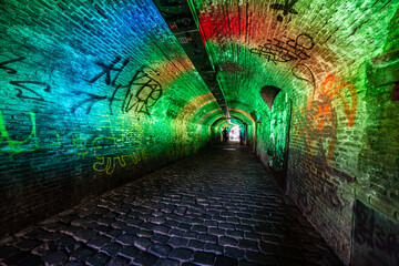 Colorfully lit tunnel from Ganzemarkt to Oudegracht in the city center of Utrecht, Utrecht...