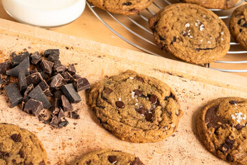 Organic food snack tasty sweet dessert milk dark chocolate chip salt cookie closeup piece fruit orange raspberry hazelnut nuts cinnamon on cocoa cacao powder wooden table for new year Christmas gift