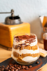 Tiramisu espresso coffee ladyfinger Italian traditional food sweet dessert homemade bakery in glass with beans short grinder