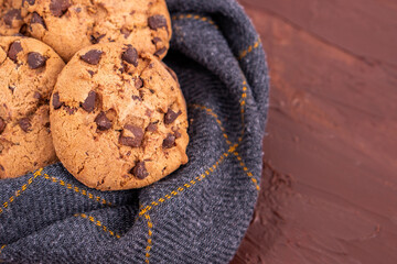 Organic food snack tasty sweet dessert milk dark chocolate chip salt cookie closeup piece fruit orange raspberry hazelnut nuts cinnamon on cocoa cacao powder wooden table for new year Christmas gift