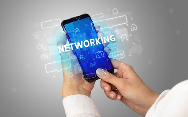 Hand using smartphone with social media concept