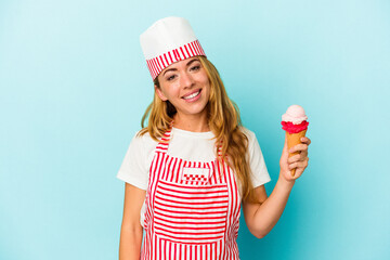 Caucasian ice cream maker woman holding an ice cream isolated on blue background happy, smiling and cheerful.