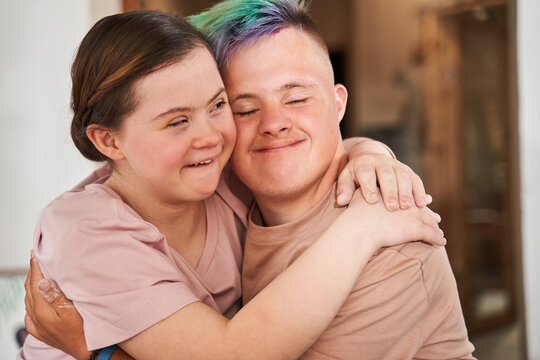 Girl with special needs embracing tight her boyfriend with colored hair
