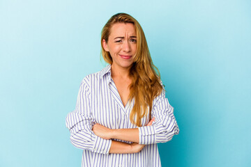 Caucasian woman isolated on blue background unhappy looking in camera with sarcastic expression.