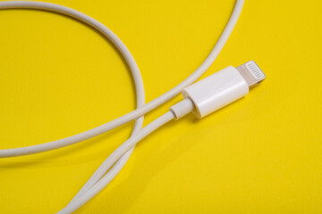 Lightning type Charger connector, for iPhone on yellow background