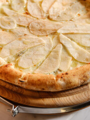 Sweet pizza dessert like Italian pie baked with fruits, mix of cheese and fruits. Closeup, selective focus, copy space for text menu or recipe
