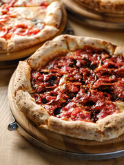 Pizza bread with pepperoni meat and red tomatoes sauce with other Italian traditional pizza assorted mix on  restaurant background 