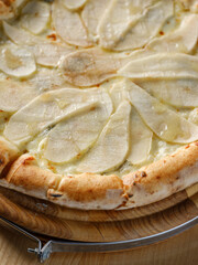 Sweet pizza dessert like Italian pie baked with fruits, mix of cheese and fruits. Closeup, selective focus, copy space for text menu or recipe
