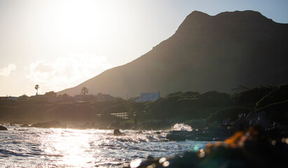 Mountain and ocean sunset view with vacation homes in the background.