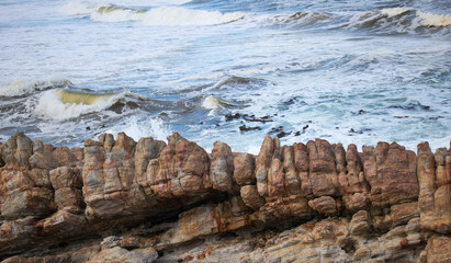 Texture background of waves in the background with rocks in the foreground.