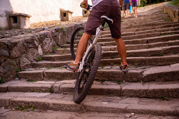 A cyclist climbs the stairs in the old town