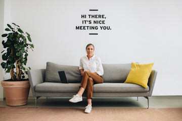 Female business professional sitting on sofa